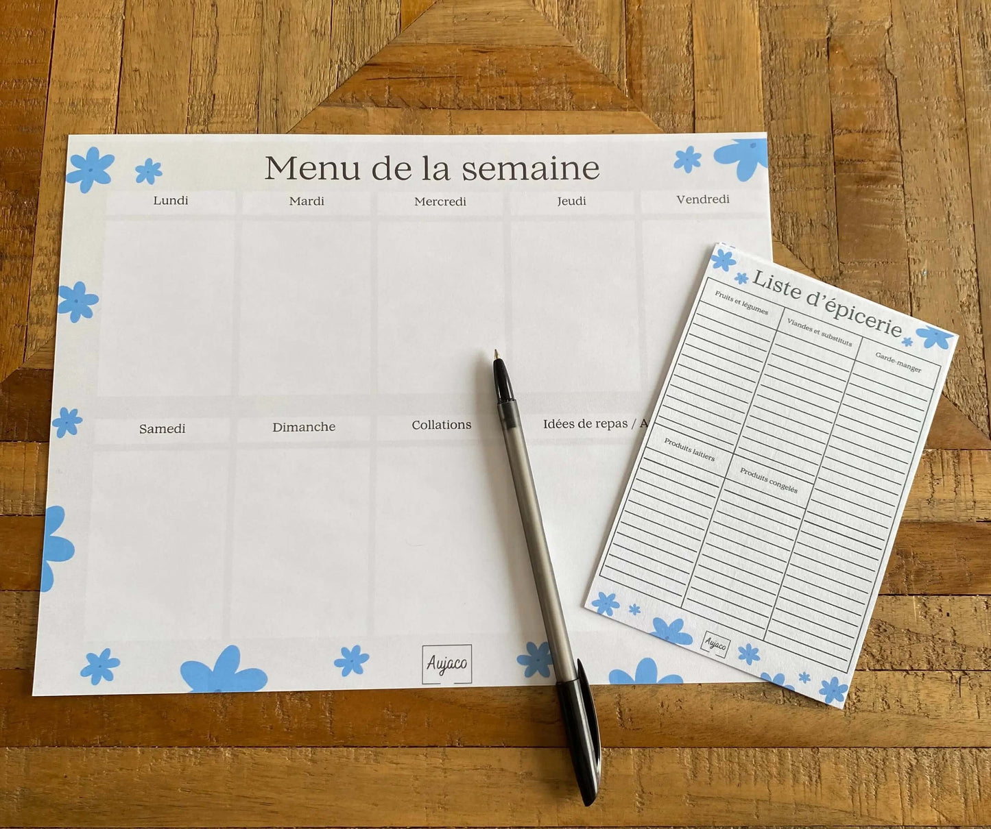 alt="Planificateur de repas hebdomadaire Fleurs bleues avec fleurs blanches délicates, sections dédiées pour chaque jour et collations, espace pour noter idées de repas et articles à acheter, format compact 8.5 x 11 pouces, 40 pages, option aimants, design moderne et durable."