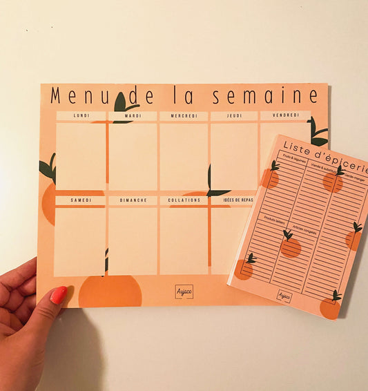 alt="Planificateur de repas hebdomadaire Citrons et Cerises de couleur orange avec petites oranges en arrière-plan, sections dédiées pour chaque jour et collations, espace pour noter idées de repas et articles à acheter, format compact 8.5 x 11 pouces, 40 pages, option aimants, design moderne et durable de Aujaco."
